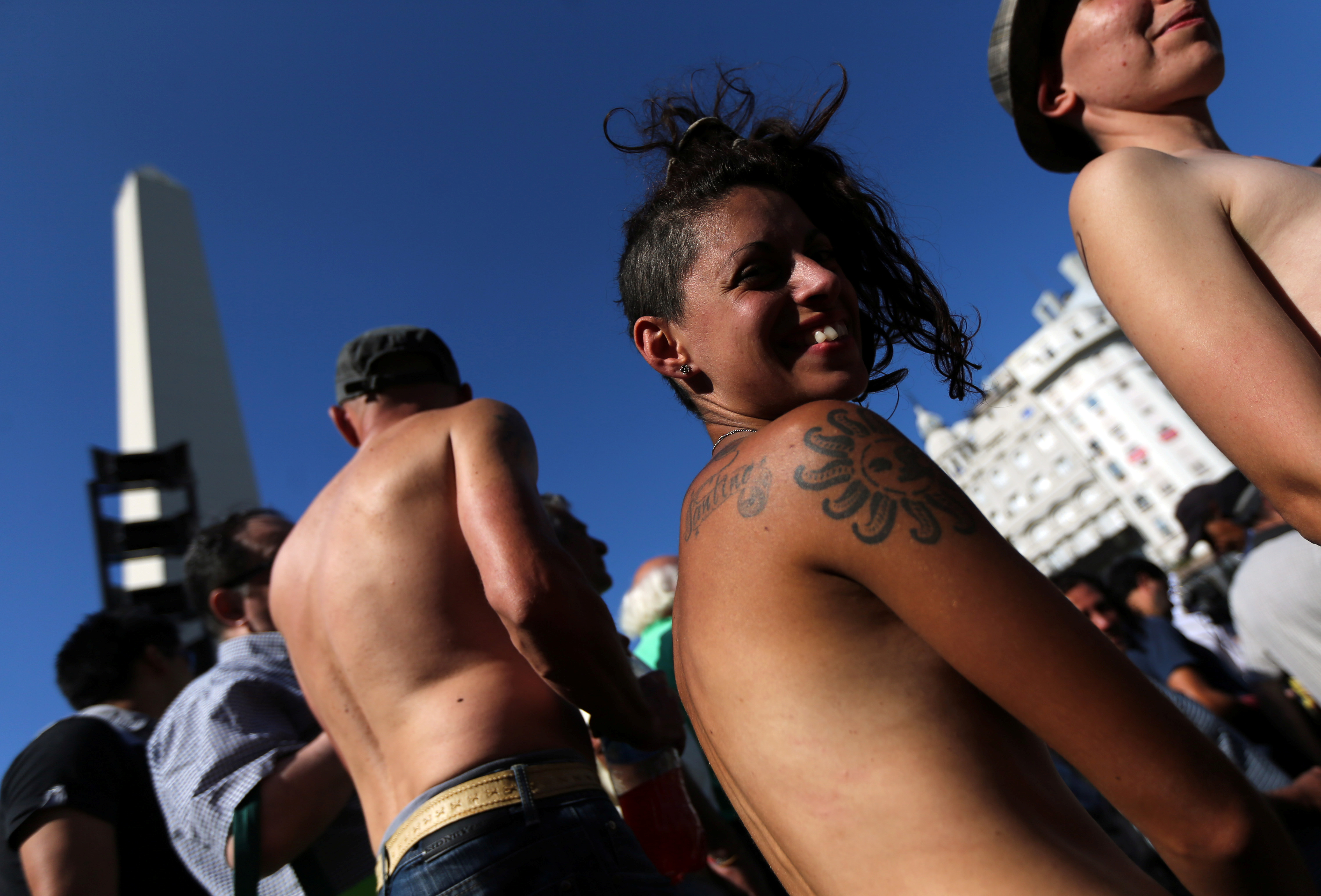 Dozens of topless women, joined by hundred of fully clothed protesters, dem...