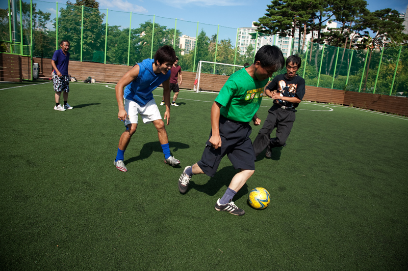 Three guys playing soccer