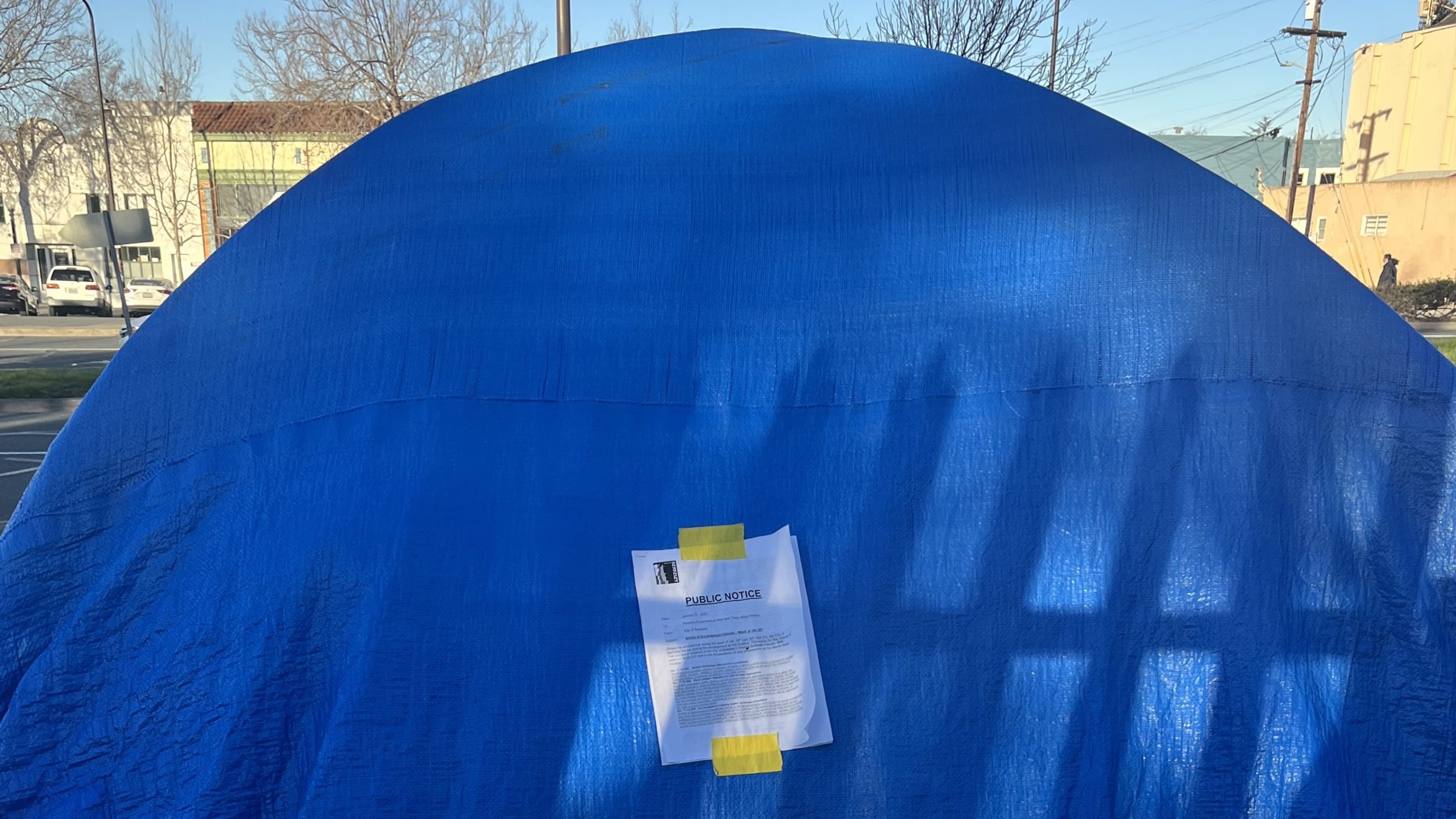 A tent from the Here There camp in South Berkeley marked with a public notice to vacate, January 31, 2023.